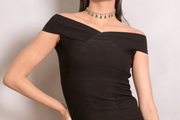 Black off-shoulder dress worn by a model against a plain background